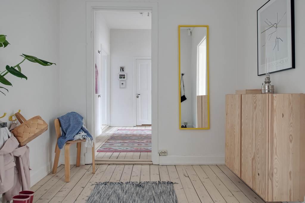 Välkomnande och ljus hall med vitsåpade originalbrädor