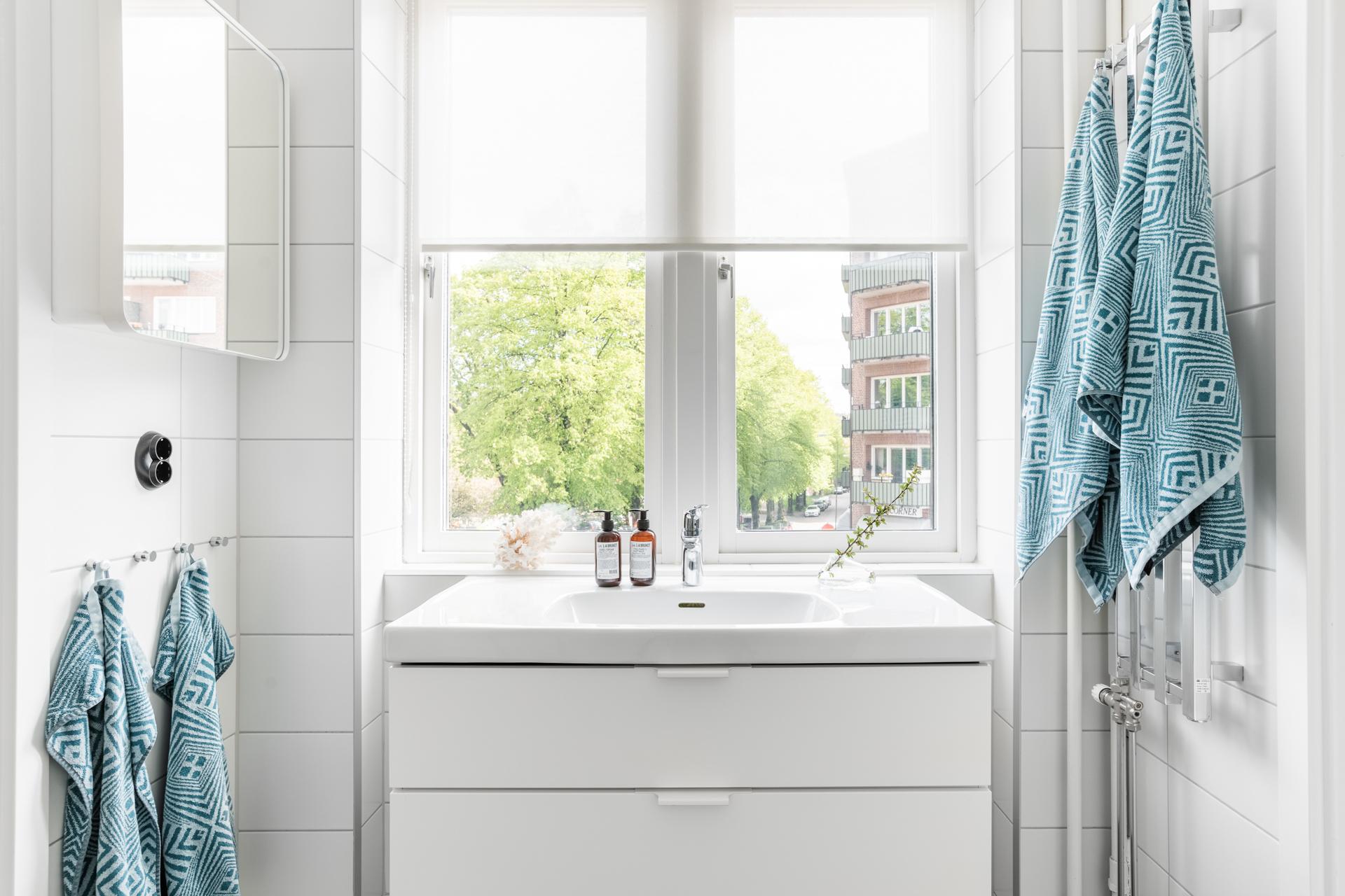 Ljust och renoverat badrum med grönskande utsikt